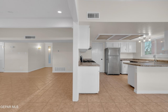 7308 Cerro Negro Dr, El Paso, TX 79912 - kitchen with freestanding refrigerator, white cabinets, light tile patterned floors, beamed ceiling, and recessed lighting