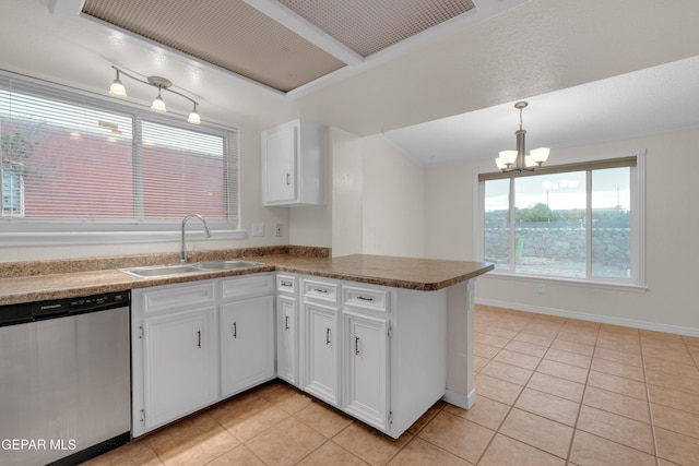 7308 Cerro Negro Dr, El Paso, TX 79912 - kitchen with stainless steel dishwasher, a chandelier, light tile patterned floors, a peninsula, and white cabinetry