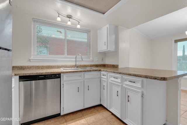 7308 Cerro Negro Dr, El Paso, TX 79912 - kitchen featuring stainless steel appliances, a peninsula, light tile patterned floors, and white cabinets