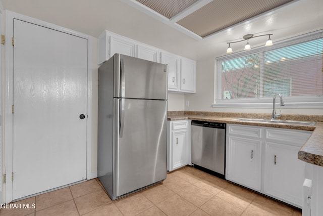 7308 Cerro Negro Dr, El Paso, TX 79912 - kitchen with appliances with stainless steel finishes, white cabinets, and light tile patterned floors