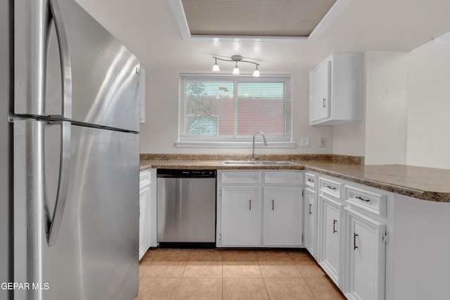 7308 Cerro Negro Dr, El Paso, TX 79912 - kitchen featuring appliances with stainless steel finishes, a tray ceiling, white cabinetry, and light tile patterned floors