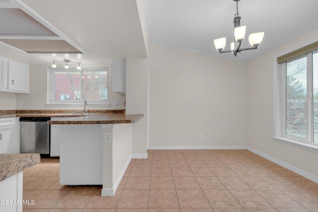 7308 Cerro Negro Dr, El Paso, TX 79912 - kitchen featuring dishwasher, white cabinets, light tile patterned floors, hanging light fixtures, and ornamental molding