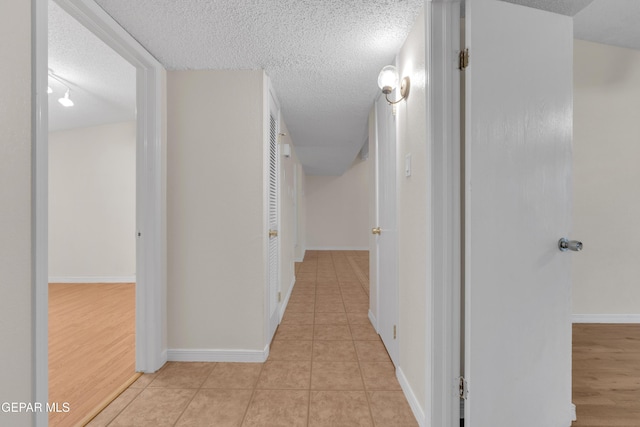7308 Cerro Negro Dr, El Paso, TX 79912 - corridor featuring a textured ceiling and light tile patterned floors