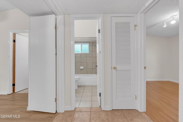 7308 Cerro Negro Dr, El Paso, TX 79912 - hall with a textured ceiling and light tile patterned floors