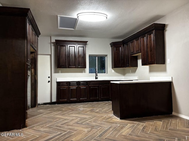 5789 Mountain Sun Dr, El Paso, TX 79938 - kitchen featuring dark brown cabinets, light countertops, and a textured ceiling