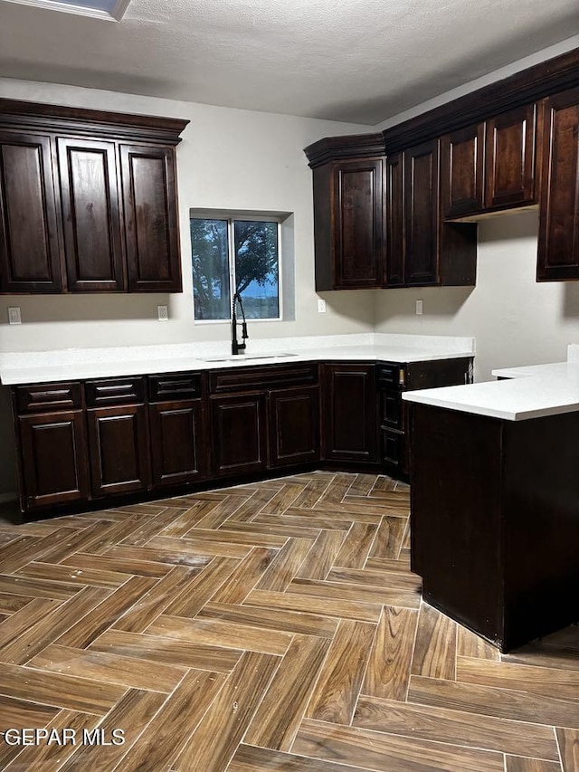 5789 Mountain Sun Dr, El Paso, TX 79938 - kitchen featuring light countertops and dark brown cabinetry