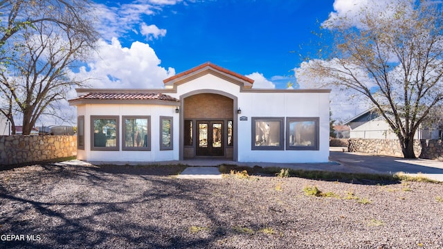 10728 Regina Dr, Socorro, TX 79927 - view of front of property with a tiled roof, stucco siding, and french doors