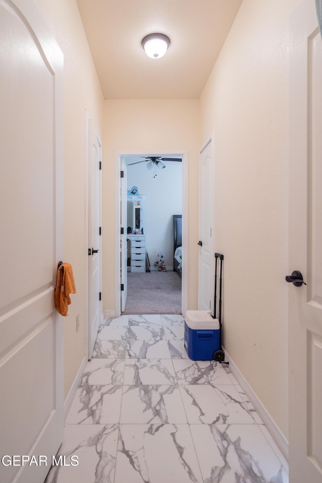 10728 Regina Dr, Socorro, TX 79927 - corridor with light marble finish floors and baseboards
