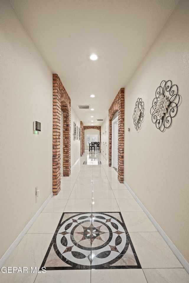 10728 Regina Dr, Socorro, TX 79927 - hallway with inlaid floor details and recessed lighting