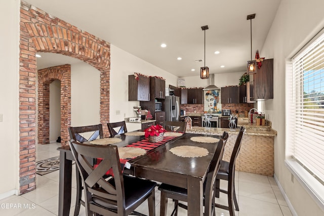 10728 Regina Dr, Socorro, TX 79927 - dining room with light tile patterned flooring, recessed lighting, and arched walkways