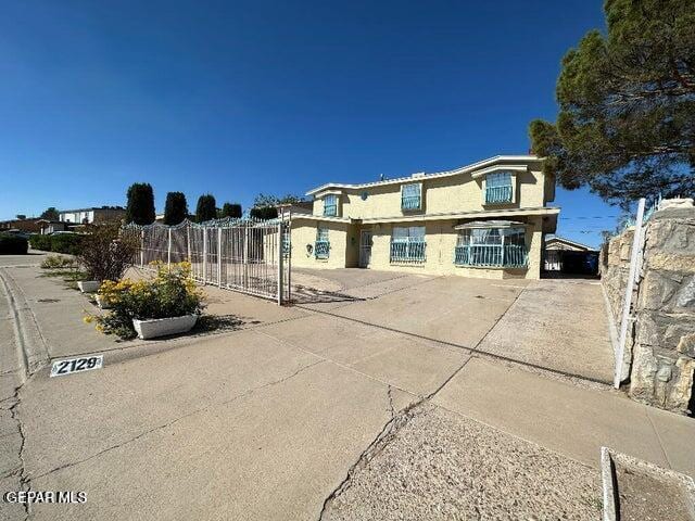 2129 Noviembre Dr, El Paso, TX 79935 - rear view of property featuring stucco siding