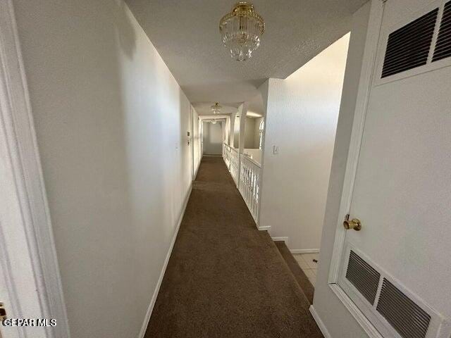 2129 Noviembre Dr, El Paso, TX 79935 - hall with a heating unit, carpet floors, and a chandelier