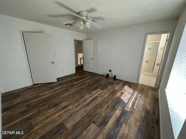 2129 Noviembre Dr, El Paso, TX 79935 - unfurnished bedroom with dark wood-style flooring, a textured ceiling, ensuite bath, a ceiling fan, and a closet