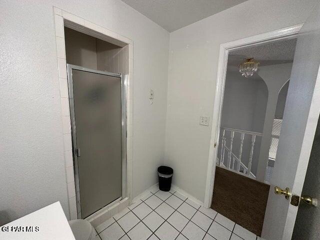 2129 Noviembre Dr, El Paso, TX 79935 - bathroom with a shower stall and tile patterned floors