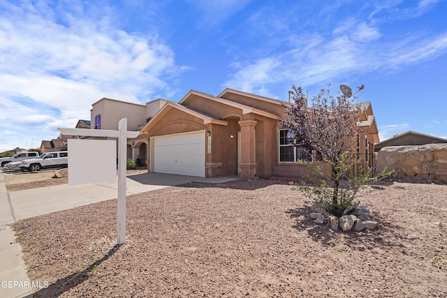 12920 Tierra Salas Dr, El Paso, TX 79938 - view of front facade with concrete driveway, an attached garage, and stucco siding