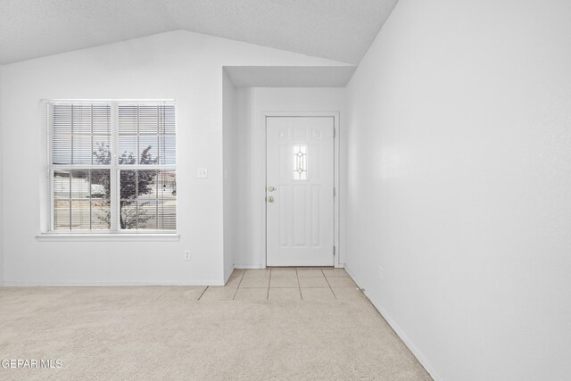 12920 Tierra Salas Dr, El Paso, TX 79938 - foyer featuring light colored carpet, lofted ceiling, healthy amount of natural light, and light tile patterned floors