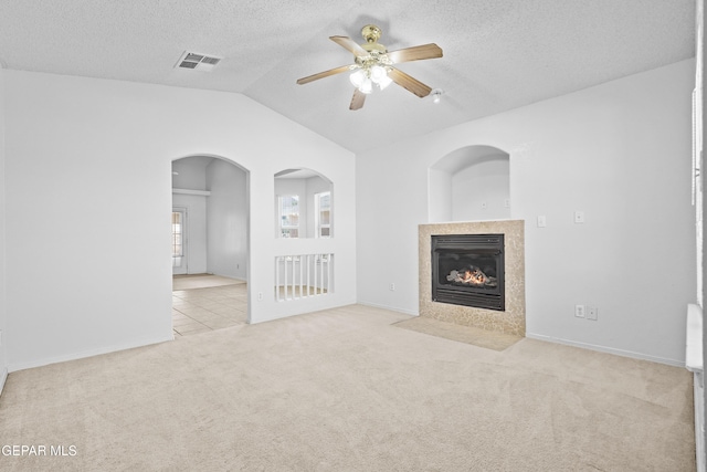 12920 Tierra Salas Dr, El Paso, TX 79938 - unfurnished living room featuring vaulted ceiling, carpet, a fireplace, ceiling fan, and a textured ceiling