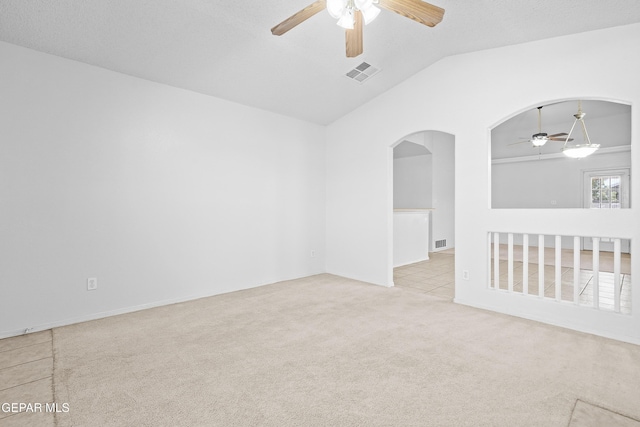 12920 Tierra Salas Dr, El Paso, TX 79938 - spare room featuring a ceiling fan, arched walkways, vaulted ceiling, and carpet flooring