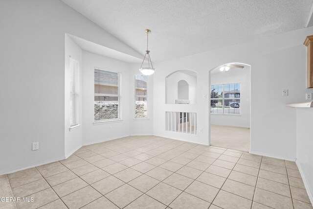 12920 Tierra Salas Dr, El Paso, TX 79938 - unfurnished dining area featuring light tile patterned flooring, lofted ceiling, and a textured ceiling