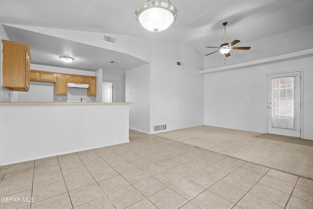 12920 Tierra Salas Dr, El Paso, TX 79938 - unfurnished living room featuring light carpet, ceiling fan, light tile patterned flooring, and high vaulted ceiling