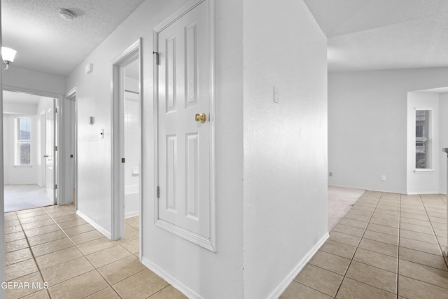 12920 Tierra Salas Dr, El Paso, TX 79938 - corridor featuring light tile patterned floors and a textured ceiling