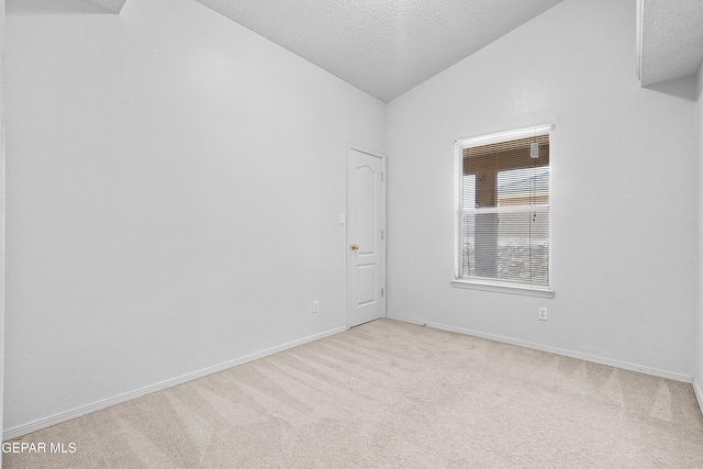 12920 Tierra Salas Dr, El Paso, TX 79938 - empty room with vaulted ceiling, carpet floors, and a textured ceiling