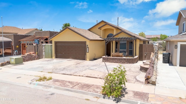 12249 Holy Springs Ct, El Paso, TX 79928 - view of front facade with concrete driveway, stucco siding, and a garage