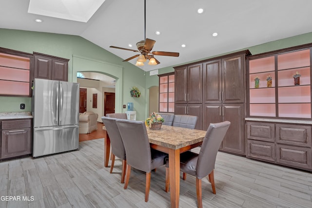 12249 Holy Springs Ct, El Paso, TX 79928 - dining room with a skylight, lofted ceiling, arched walkways, light wood-style floors, and ceiling fan