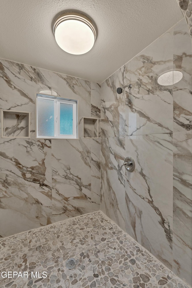 12249 Holy Springs Ct, El Paso, TX 79928 - full bathroom with a marble finish shower and a textured ceiling