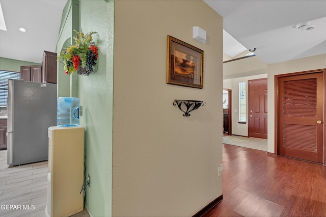 12249 Holy Springs Ct, El Paso, TX 79928 - corridor with light wood finished floors and vaulted ceiling