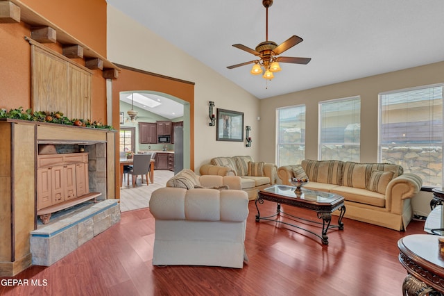 12249 Holy Springs Ct, El Paso, TX 79928 - living area featuring vaulted ceiling, ceiling fan, wood finished floors, and arched walkways
