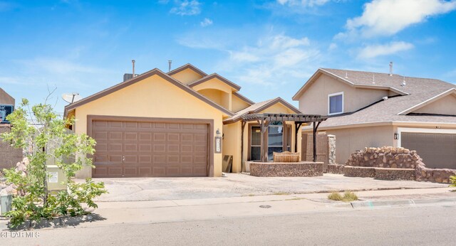 12249 Holy Springs Ct, El Paso, TX 79928 - view of front of house featuring a garage, stucco siding, and concrete driveway