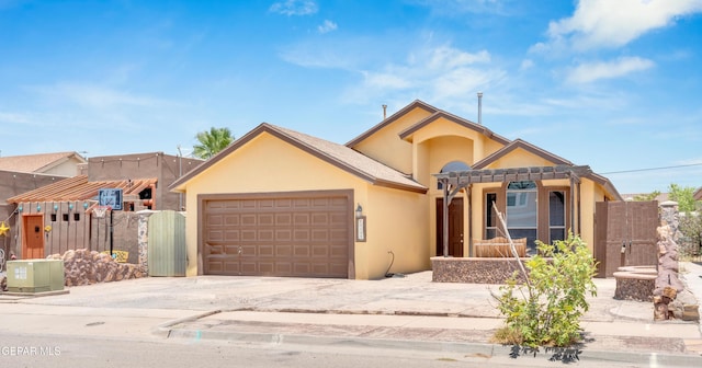 12249 Holy Springs Ct, El Paso, TX 79928 - view of front of home with a garage, stucco siding, concrete driveway, and a gate