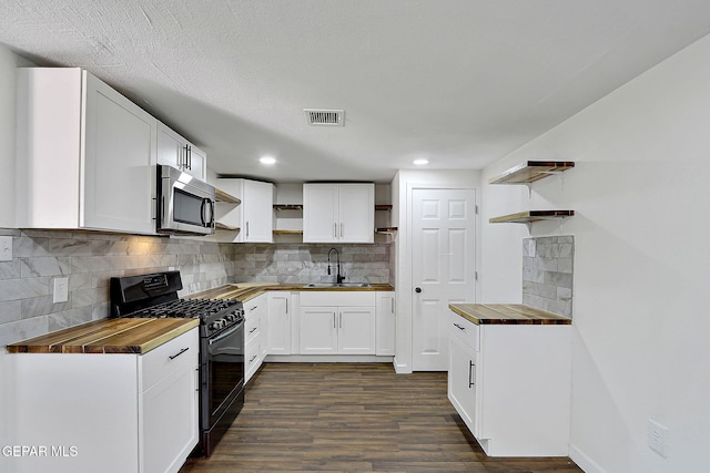 4437 Skyline Ave, El Paso, TX 79904 - kitchen featuring open shelves, wood counters, black gas range, and recessed lighting