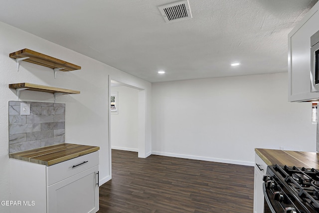 4437 Skyline Ave, El Paso, TX 79904 - kitchen with wooden counters, dark wood finished floors, gas stove, recessed lighting, and open shelves