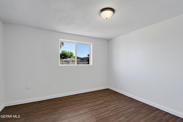 4437 Skyline Ave, El Paso, TX 79904 - empty room featuring dark wood-style flooring and a textured ceiling