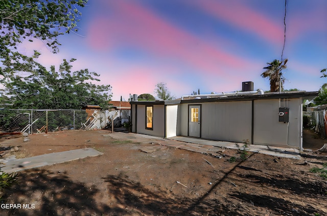 4437 Skyline Ave, El Paso, TX 79904 - back of property at dusk with a fenced backyard and a patio area