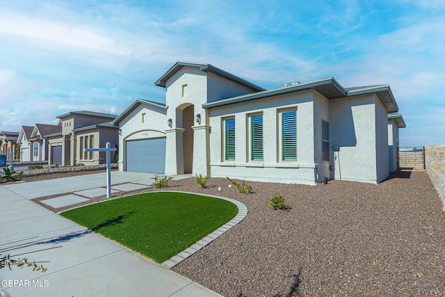 1798 Dana Gray St, El Paso, TX 79928 - view of front of house with stucco siding, driveway, and a garage
