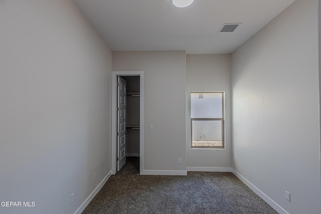 1798 Dana Gray St, El Paso, TX 79928 - unfurnished bedroom featuring a walk in closet, dark colored carpet, and a closet
