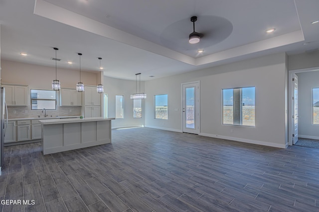 1798 Dana Gray St, El Paso, TX 79928 - kitchen featuring open floor plan, a ceiling fan, dark wood finished floors, light countertops, and a raised ceiling