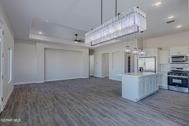 1798 Dana Gray St, El Paso, TX 79928 - kitchen featuring appliances with stainless steel finishes, light countertops, white cabinetry, tasteful backsplash, and open floor plan