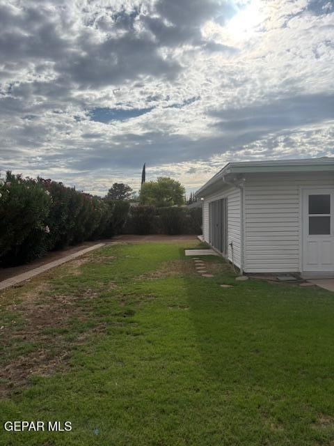 10700 Janway Dr, El Paso, TX 79935 - view of grassy yard with an outbuilding