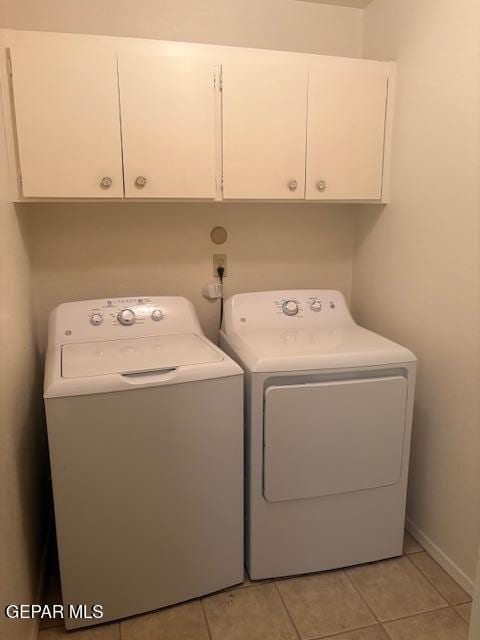 10700 Janway Dr, El Paso, TX 79935 - washroom with cabinet space, washer and clothes dryer, and light tile patterned flooring