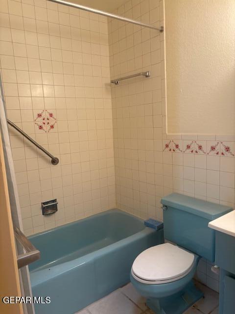 10700 Janway Dr, El Paso, TX 79935 - full bathroom with tile walls, vanity, bathtub / shower combination, and tile patterned floors