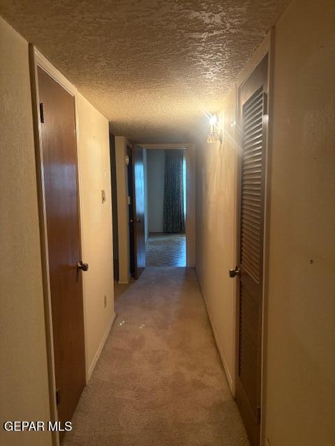 10700 Janway Dr, El Paso, TX 79935 - hall with a textured ceiling and light colored carpet