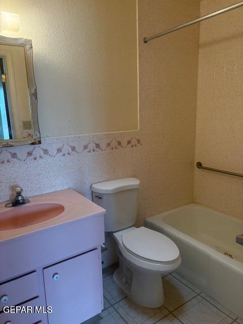 10700 Janway Dr, El Paso, TX 79935 - bathroom with vanity, tile patterned floors, wainscoting, and tile walls