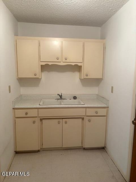 10700 Janway Dr, El Paso, TX 79935 - kitchen featuring cream cabinetry, light countertops, and a textured ceiling