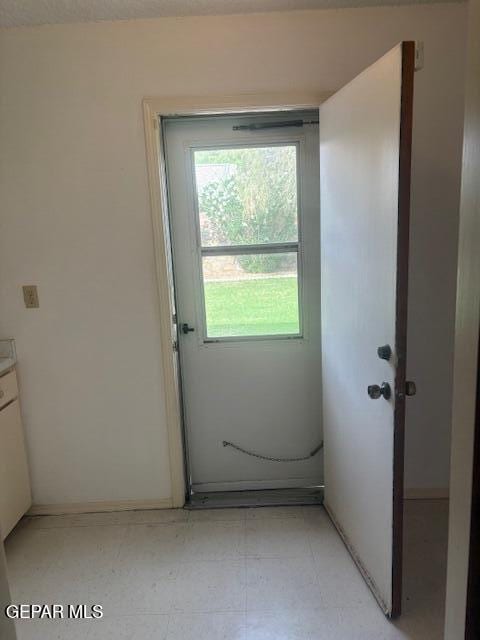 10700 Janway Dr, El Paso, TX 79935 - doorway with light floors and baseboards