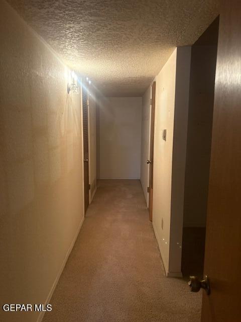 10700 Janway Dr, El Paso, TX 79935 - corridor with light carpet and a textured ceiling
