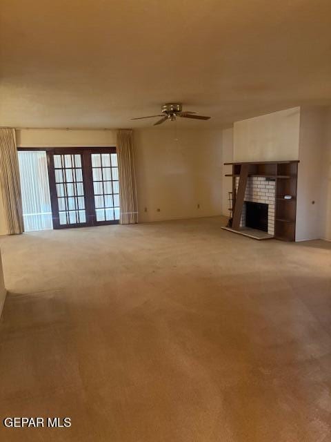 10700 Janway Dr, El Paso, TX 79935 - unfurnished living room with a ceiling fan, a fireplace, and carpet flooring
